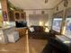 Bright living room with a couch, and views to the kitchen and dining area at 1206 W Klamath Dr, Apache Junction, AZ 85119