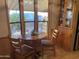 Cozy dining area with a round wooden table and built-in hutch at 1206 W Klamath Dr, Apache Junction, AZ 85119