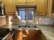 Clean kitchen with double sink, wood cabinets, and stainless steel appliances at 1206 W Klamath Dr, Apache Junction, AZ 85119