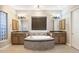 Elegant bathroom with double vanities and a large soaking tub at 2378 N 158Th Dr, Goodyear, AZ 85395