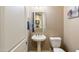 Convenient powder room with pedestal sink and toilet at 2378 N 158Th Dr, Goodyear, AZ 85395