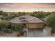 Single-story home with three-car garage and mature desert landscaping at 2378 N 158Th Dr, Goodyear, AZ 85395