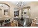 Formal dining room with chandelier and views to library at 2378 N 158Th Dr, Goodyear, AZ 85395