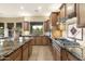 Modern kitchen with granite countertops and gas cooktop at 2378 N 158Th Dr, Goodyear, AZ 85395