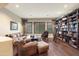 Spacious living room with leather furniture and built-in bookcase at 2378 N 158Th Dr, Goodyear, AZ 85395