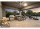 Outdoor kitchen with grill and bar seating at 2378 N 158Th Dr, Goodyear, AZ 85395