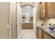 Elegant hallway with view into kitchen and wet bar at 2378 N 158Th Dr, Goodyear, AZ 85395