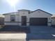 New single-story home with a two-car garage and desert landscaping at 8455 W Mantle Way, Florence, AZ 85132