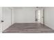 Simple bedroom with wood-look floors and access to another room at 10338 E San Salvador Dr, Scottsdale, AZ 85258