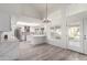 Open concept kitchen with white cabinets, marble countertops and island at 10338 E San Salvador Dr, Scottsdale, AZ 85258