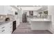 Updated kitchen featuring white cabinets, stone backsplash, and stainless steel appliances at 10338 E San Salvador Dr, Scottsdale, AZ 85258
