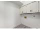 Laundry room with white cabinets and vinyl flooring at 10338 E San Salvador Dr, Scottsdale, AZ 85258