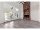 Living area with brick fireplace and hardwood floors, and access to patio at 10338 E San Salvador Dr, Scottsdale, AZ 85258