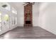 Living area with brick fireplace and hardwood floors, and access to patio at 10338 E San Salvador Dr, Scottsdale, AZ 85258