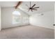 Main bedroom with vaulted ceiling, window and carpet floor at 10338 E San Salvador Dr, Scottsdale, AZ 85258