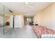 Bright bedroom with mirrored wall and view of living area at 4630 N 68Th St # 248, Scottsdale, AZ 85251