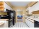Modern kitchen featuring black appliances and view into living area at 4630 N 68Th St # 248, Scottsdale, AZ 85251