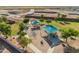 Aerial view of a community park with playground equipment and shaded areas at 38120 W Excussare Way, Maricopa, AZ 85138