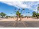 Community entrance with a central fountain and flags at 8228 E Calypso Ave, Mesa, AZ 85208