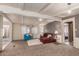 Living room with a red sectional sofa and blue armchair at 8228 E Calypso Ave, Mesa, AZ 85208