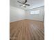 Spacious bedroom with wood-like floor and ceiling fan at 8214 E Mcdonald Dr, Scottsdale, AZ 85250