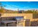 Built-in outdoor kitchen with a gas grill and mini-fridge at 24779 N 91St St, Scottsdale, AZ 85255