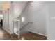 Upper hallway with wood floors and modern metal railing at 6745 N 93Rd Ave # 1133, Glendale, AZ 85305