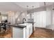 Eat-in kitchen with farmhouse sink, white cabinets, and dark countertops at 6745 N 93Rd Ave # 1133, Glendale, AZ 85305