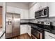 Modern kitchen with stainless steel appliances and dark countertops at 6745 N 93Rd Ave # 1133, Glendale, AZ 85305