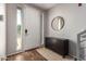 Bright entryway with wood floors, a dark console table, and a large mirror at 6745 N 93Rd Ave # 1133, Glendale, AZ 85305