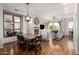 Open dining area with farmhouse table and chairs, adjacent to living room at 6745 N 93Rd Ave # 1133, Glendale, AZ 85305