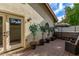 Cozy patio with brick pavement, potted plants, and french doors at 10338 E San Salvador Dr, Scottsdale, AZ 85258