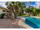 Inviting kidney-shaped pool with a spacious backyard and lush landscaping at 10338 E San Salvador Dr, Scottsdale, AZ 85258