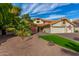 Two-story house with a three-car garage and a beautifully landscaped yard at 10338 E San Salvador Dr, Scottsdale, AZ 85258