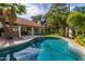 Relaxing kidney-shaped pool with surrounding landscaping at 10338 E San Salvador Dr, Scottsdale, AZ 85258