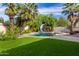 Inviting backyard pool with grassy area and slide at 10338 E San Salvador Dr, Scottsdale, AZ 85258