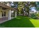 Spacious backyard with grassy lawn, mature trees, and a hammock at 10338 E San Salvador Dr, Scottsdale, AZ 85258