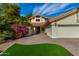 Front view of a house with a two-car garage and nicely landscaped area at 10338 E San Salvador Dr, Scottsdale, AZ 85258