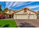 Two story house with three car garage and manicured lawn at 10338 E San Salvador Dr, Scottsdale, AZ 85258