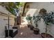 Brick paved courtyard with potted plants and seating area at 10338 E San Salvador Dr, Scottsdale, AZ 85258