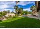 Kidney shaped pool with a slide, surrounded by lush landscaping at 10338 E San Salvador Dr, Scottsdale, AZ 85258