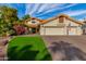 Two-story house with a three-car garage, lush landscaping, and brick driveway at 10338 E San Salvador Dr, Scottsdale, AZ 85258