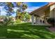 Backyard oasis with lush landscaping, a covered patio, and pool at 10338 E San Salvador Dr, Scottsdale, AZ 85258