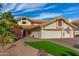 Two-story house with tile roof, two-car garage, and landscaped front yard at 10338 E San Salvador Dr, Scottsdale, AZ 85258