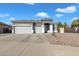 Single story home with a two-car garage and landscaped yard at 2020 S Sabrina --, Mesa, AZ 85209