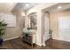Elegant entry hall with hardwood floors, Buddha statue, and artwork at 7297 N Scottsdale Rd # 1004, Paradise Valley, AZ 85253