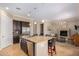 Open concept kitchen features granite island with seating, stainless steel appliances and fireplace at 7297 N Scottsdale Rd # 1004, Paradise Valley, AZ 85253