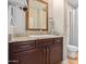 Bathroom with granite countertop, sink, and dark brown vanity at 7297 N Scottsdale Rd # 1004, Paradise Valley, AZ 85253
