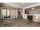 Living room with hardwood floors, fireplace and access to balcony at 7297 N Scottsdale Rd # 1004, Paradise Valley, AZ 85253