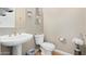 Clean bathroom with pedestal sink, toilet and decorative accents at 7297 N Scottsdale Rd # 1004, Paradise Valley, AZ 85253